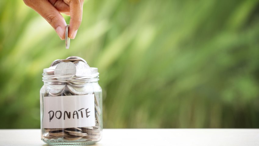 Image of a person adding a quarter into a jar
