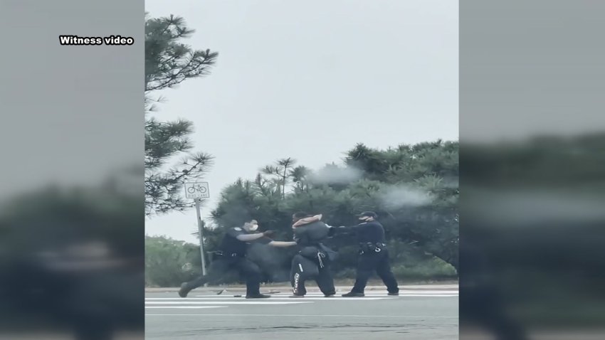 Two San Diego Police Department officers' actions are under investigation by the Internal Affairs Unit after they were captured on camera hitting a man who they had already taken down in the middle of a major intersection in La Jolla on Wednesday, May 12, 2021.