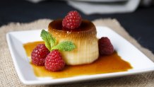 Egg flan with raspberries and mint leaves