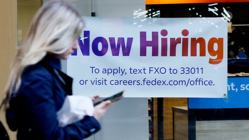 A “Now Hiring” sign is displayed on a shopfront on October 21, 2022 in New York City.