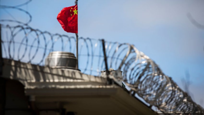 The flag of the People’s Republic of China flies behind barbed wire at the Consulate General of the People’s Republic of China in San Francisco, California on July 23, 2020. – The US Justice Department announced July 23, 2020 the indictments of four Chinese researchers it said lied about their ties to the People’s Liberation Army, with one escaping arrest by taking refuge in the country’s San Francisco consulate. (Photo by Philip Pacheco / AFP) (Photo by PHILIP PACHECO/AFP via Getty Images)