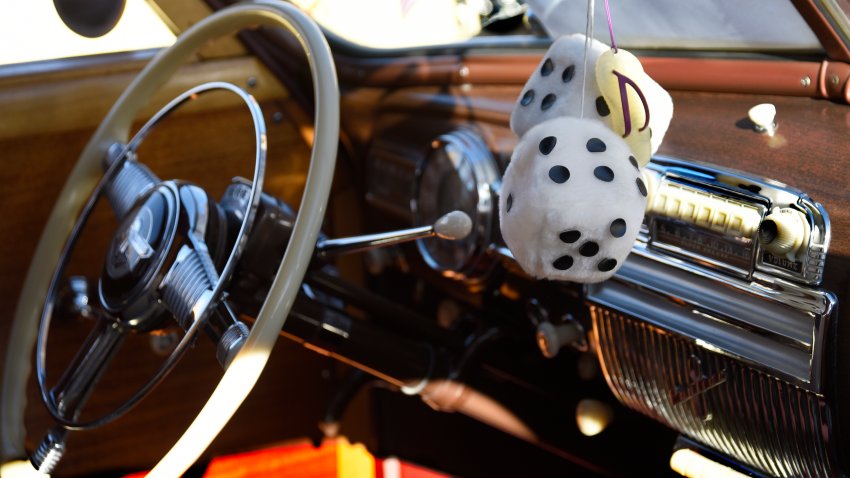 SANTA FE, NM – NOVEMBER 25, 2017:  A pair of ‘fuzzy dice’ hang from the rearview mirror of a classic car on display in Santa Fe, New Mexico. (Photo by Robert Alexander/Getty Images)