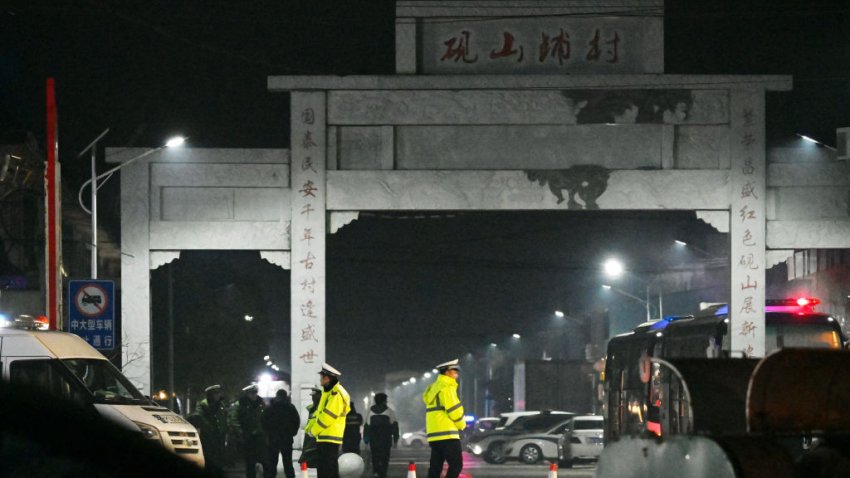 Police stand guard after a school was engulfed by fire in Yanshanpu in China’s Henan province on January 20, 2024. Thirteen schoolchildren died in a dormitory fire in central China’s Henan province, the official Xinhua news agency reported on January 20. (Photo by GREG BAKER / AFP) (Photo by GREG BAKER/AFP via Getty Images)