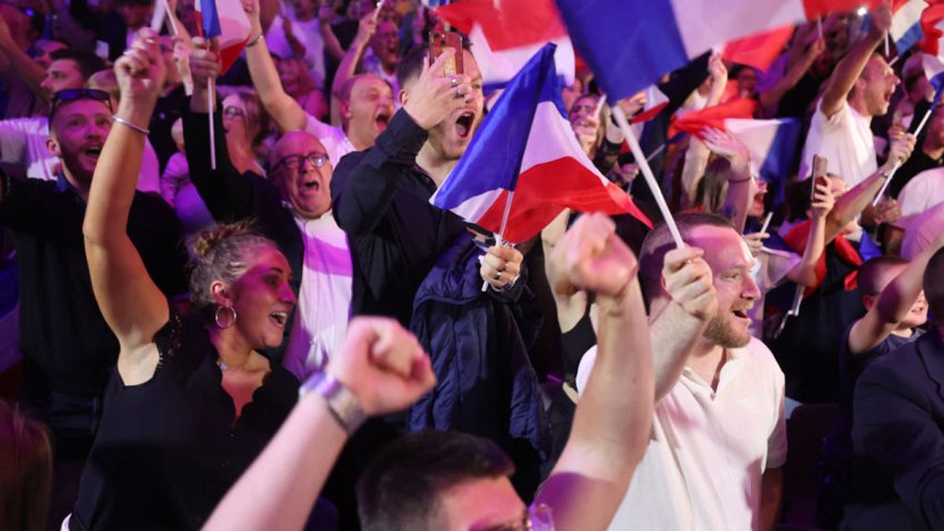 Supporters react as former president of the French far-right Rassemblement National (RN) parliamentary group Marine Le Pen gives a speech during the results evening of the first round of the parliamentary elections in Henin-Beaumont, northern France, on June 30, 2024. A divided France is voting in high-stakes parliamentary elections that could see the anti-immigrant and eurosceptic party of Marine Le Pen sweep to power in a historic first. The candidates formally ended their frantic campaigns at midnight June 28, with political activity banned until the first round of voting. (Photo by FRANCOIS LO PRESTI / AFP) (Photo by FRANCOIS LO PRESTI/AFP via Getty Images)