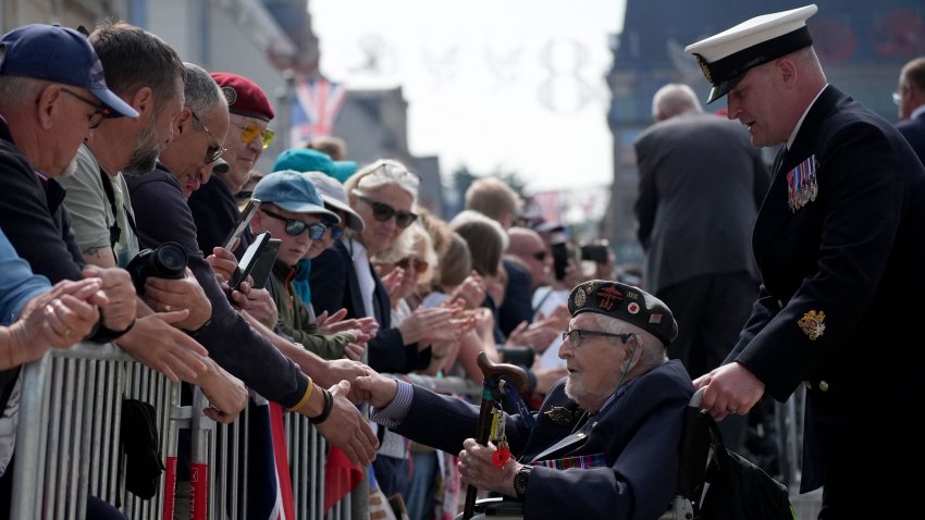 ARROMANCHES-LES-BAINS, FRANCE – JUNE 6: A British D-Day veteran is greeted as he attends a parade with a Royal Guard Of Honour on June 6, 2024 in Arromanches-les-Bains, France. Normandy is hosting various events across significant sites such as Pegasus Bridge, Sainte-Mère-Église, and Pointe du Hoc, leading up to the official commemoration of the 80th anniversary of the D-Day landing on June 6. (Photo by Christopher Furlong/Getty Images)