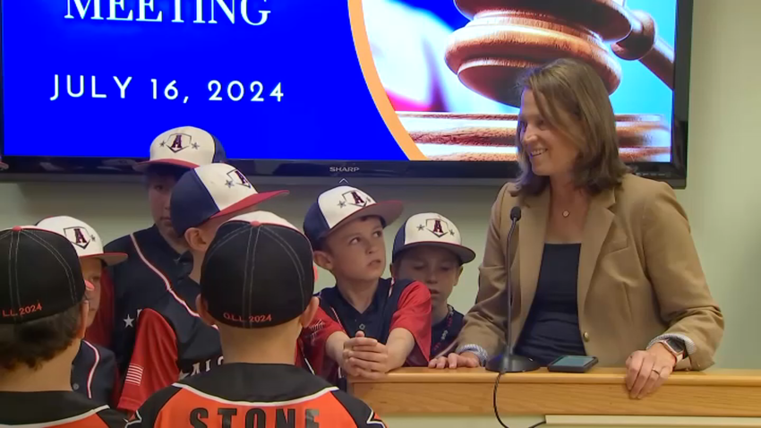 Dr. Jennifer LaFemina and members of her son's Little League team at the Oxford, Mass., town meeting where she and others were honored for saving an umpire's life.