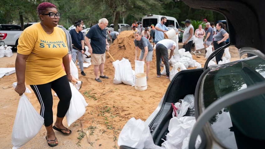 TALLAHASSEE, FLORIDA – SEPTEMBER 25: Tallahassee State professor Pamela Andrews carriers sand bags to a car in preparation for possible flooding as Tropical Storm Helene heads toward the state’s Gulf Coast on September 25, 2024 in Tallahassee, Florida. Currently, Tropical Storm Helene is forecast to become a major hurricane, bringing the potential for deadly storm surges, flooding rain, and destructive hurricane-force winds along parts of the Florida West Coast. Helene is expected to make landfall in Florida on Thursday. (Photo by Sean Rayford/Getty Images)