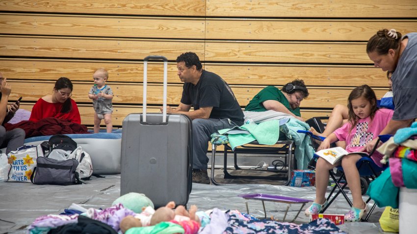 Marlon Ng, center, evacuated his family to a shelter