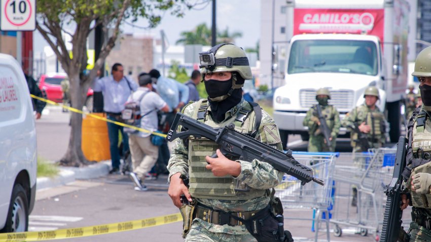 EDITORS NOTE: Graphic content / Members of the Mexican Army are seen in the car park of a shop where the body of a man was found in the Montebello neighborhood of Culiac√°n, Sinaloa State, Mexico, on September 12, 2024. Spiraling criminal violence, much of it linked to drug trafficking and gangs, has seen more than 450,000 people murdered in Mexico since 2006. (Photo by Ivan MEDINA / AFP) (Photo by IVAN MEDINA/AFP via Getty Images)