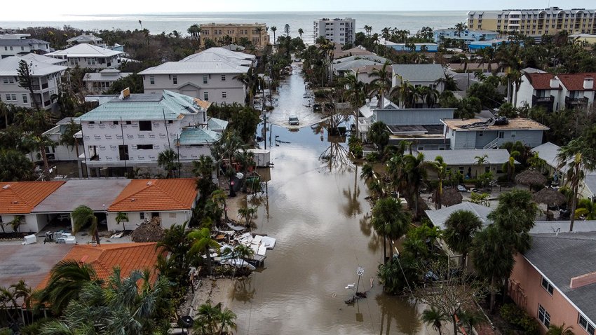 In this aerial photo, a vehicle drives though a flooded street after Hurricane Milton, in Siesta Key, Florida, on October 10, 2024. At least 10 people were dead after Hurricane Milton smashed into Florida, US authorities said October 10, 2024, after the monster weather system sent tornados spinning across the state and flooded swaths of the Tampa Bay area. (Photo by CHANDAN KHANNA / AFP) (Photo by CHANDAN KHANNA/AFP via Getty Images)