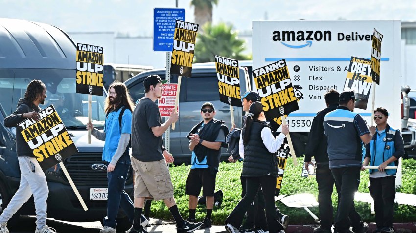 Amazon workers walk the picket line outside an Amazon facility in the City of Industry, California on December 19, 2024. Thousands of workers at Amazon facilities across the United States went on strike December 19, 2024, the Teamsters Union said, halting work at the height of the busy holiday gift-giving season. (Photo by Frederic J. BROWN / AFP) (Photo by FREDERIC J. BROWN/AFP via Getty Images)