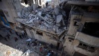 People inspect a house after an Israeli airstrike in Gaza City, on March 19, 2025. The Israeli military drops leaflets warning residents of what it calls ”combat areas” in the north and south of the besieged Palestinian territory, after Israel resumes airstrikes on Gaza following a ceasefire breakdown. (Photo by Majdi Fathi/NurPhoto via Getty Images)
