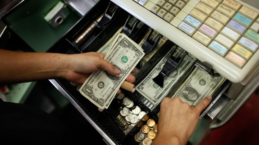 MIAMI – MAY 20:  Yera Dominguez counts out change from a transaction at Lorenzo’s Italian Market on May 20, 2009 in Miami, Florida. Members of Congress today passed a bill placing new restrictions on companies that issues credit. The vote follows the Senate passage of the bill, which now heads for President Obama’s promised signature. The bill will curb sudden interest rate increases and hidden fees, requiring card companies to tell customers of rate increases 45 days in advance. It will also make it harder for people aged below 21 to be issued credit cards.  (Photo by Joe Raedle/Getty Images)